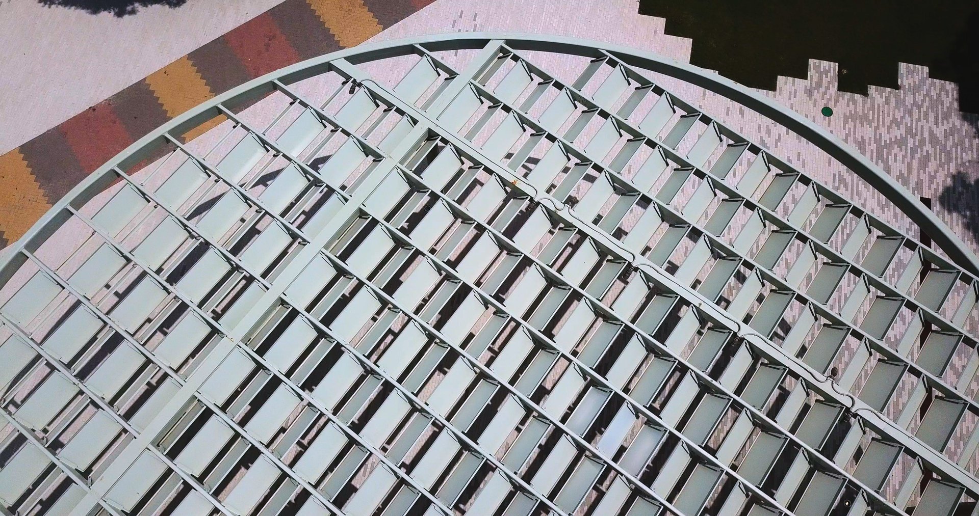 Aerial view of the Emma S. Barrientos Mexican American Cultural Center and its elliptical canopy against the downtown Austin skyline